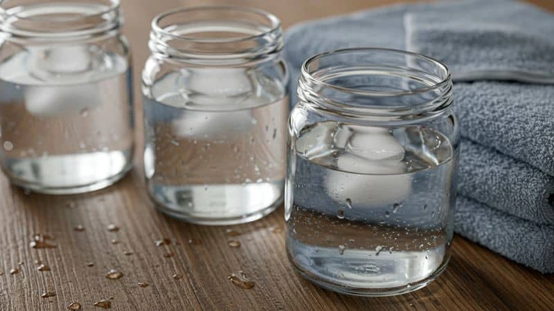 Potinhos de vidro com água e toalhas úmidas ao redor-umidificador caseiro